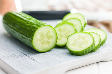 Sliced fresh green cucumber on the cutting board.の写真素材