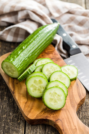 Sliced fresh green cucumber on the cutting board.の写真素材
