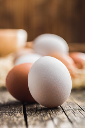 Whole chicken eggs on the wooden table.の写真素材