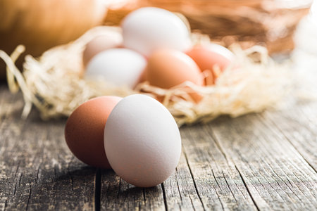 Whole chicken eggs on the wooden table.