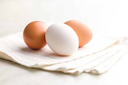 Whole chicken eggs on the kitchen napkin.の写真素材