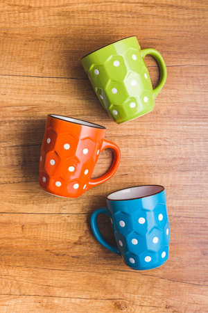 The polka dot mug on the wooden table. Top view.の写真素材