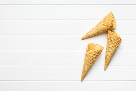 Empty wafer cone. Sweet ice cream cone on the kitchen table. Top view.の写真素材
