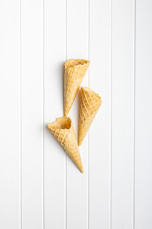 Empty wafer cone. Sweet ice cream cone on the kitchen table. Top view.の写真素材