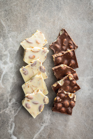 White and dark chocolate bars on the kitchen table. Top view.の写真素材