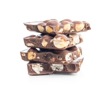 Broken chocolate bars with nuts isolated on the white background.の写真素材