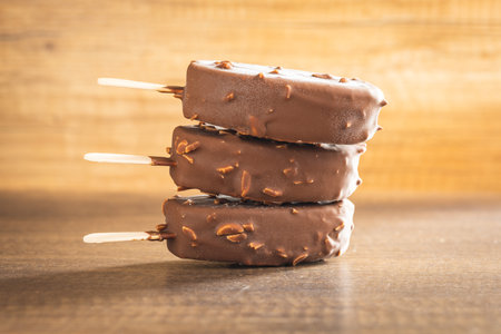 ice creams covered with chocolate on the wooden table.の写真素材