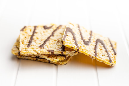 Puffed corn crackers chocolate covered on the white table.の写真素材