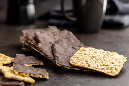 Puffed corn crackers chocolate covered on the black table.の写真素材