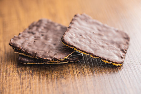 Puffed corn crackers chocolate covered on the wooden table.の写真素材