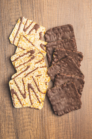 Puffed corn crackers chocolate covered on the wooden table. Top view.の写真素材