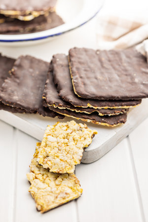 Puffed corn crackers chocolate covered on the white table.の写真素材