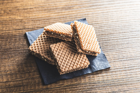 Sweet chocolate wafer on the wooden table.の写真素材