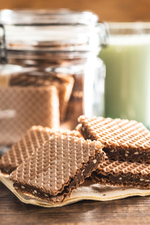 Sweet chocolate wafer on the wooden table.の写真素材
