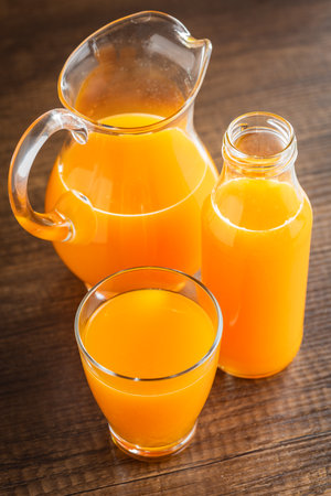 A glass of fruit juice. Orange juice on the wooden table.の写真素材