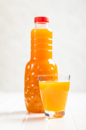 A glass of fruit juice. Orange juice on the white table.の写真素材