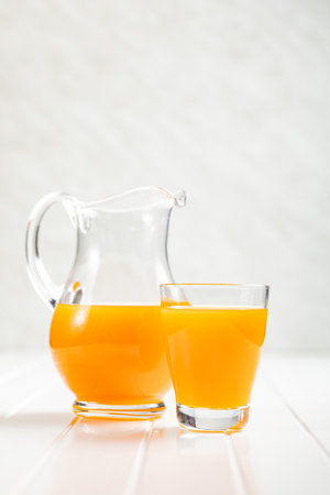 A glass of fruit juice. Orange juice on the white table.の写真素材