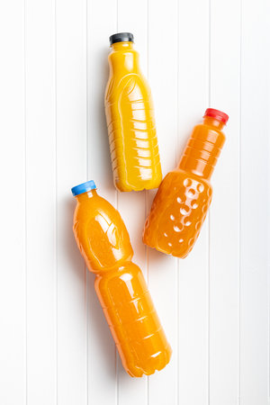 A plastic bottle of fruit juice. Orange juice on the white table.の写真素材