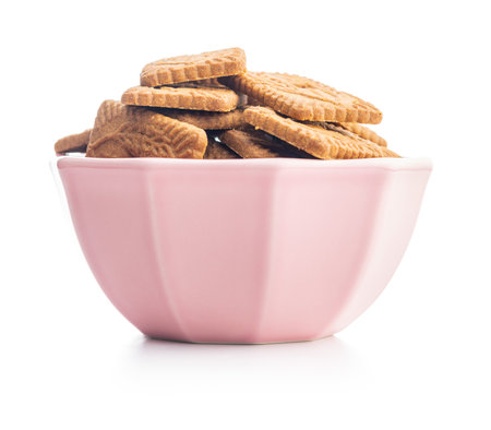 Sweet caramel biscuits. Tasty cookies in bowl isolated on the white background.の写真素材