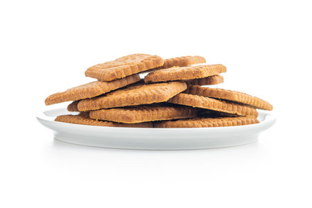Sweet caramel biscuits. Tasty cookies on plate isolated on the white background.の写真素材