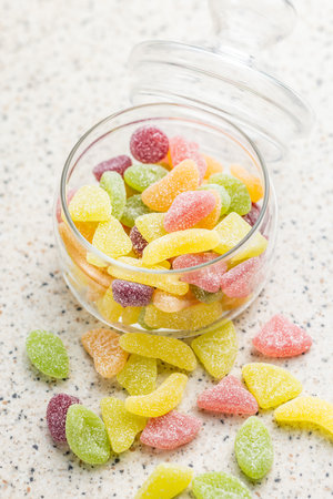 Mix of fruity jelly candy in a jar on the kitchen table.の写真素材