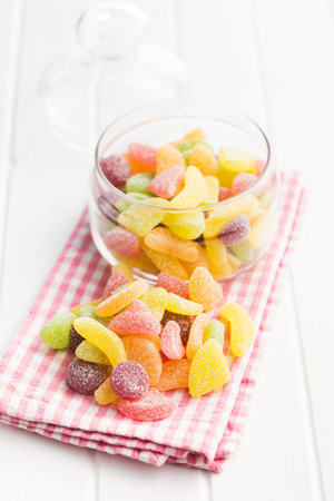 Mix of fruity jelly candy on the checkered napkin.の写真素材