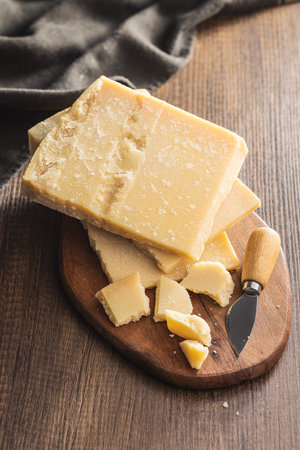 Tasty parmesan cheese on the cutting board.の写真素材