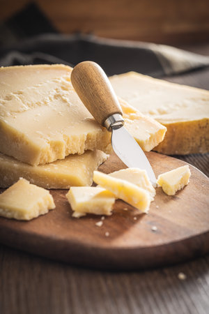 Tasty parmesan cheese on the cutting board.の写真素材