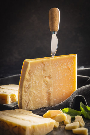 Tasty parmesan cheese on the black table.の写真素材