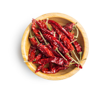 Red chili peppers in a bowl isolated on the white background.の写真素材