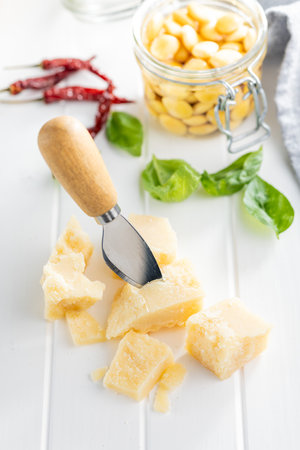 Tasty parmesan cheese on the white table.の写真素材