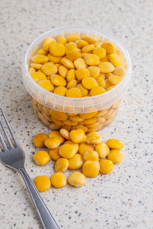 Lupini beans in brine. Pickled lupine in bowl on the kitchen table.の写真素材