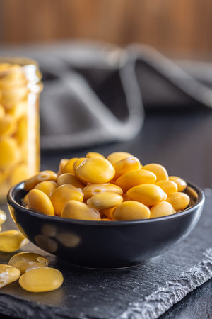Lupini beans in brine. Pickled lupine in bowl on the black table.の写真素材