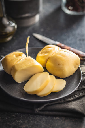 Smoked scamorza cheese on the plate.の写真素材