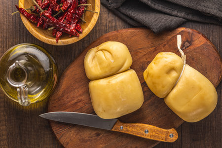Smoked scamorza cheese on the cutting board. Top view.の写真素材