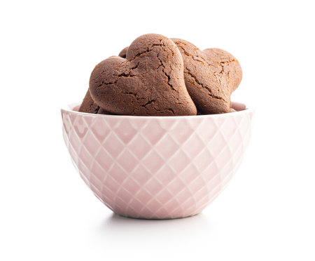Heart shaped cookies in a bowl isolated on the white background.の写真素材