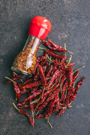 The whole and milled red chili peppers. Top view.の写真素材