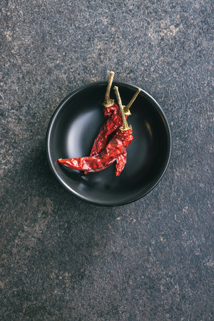 Red chili peppers in the bowl. Top view.の写真素材