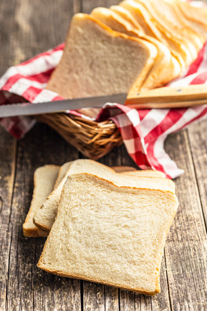 White sliced toast bread on the wooden table.の写真素材