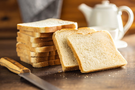 White sliced toast bread on the wooden table.の写真素材