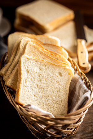White sliced toast bread on the wooden table.の写真素材