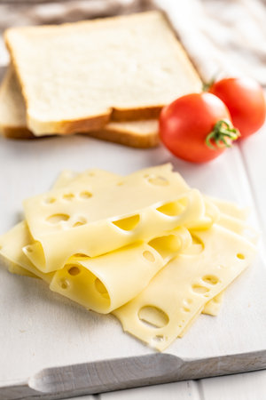 Slices of cheese on the cutting board.の写真素材