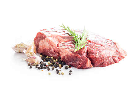 Raw fillet steak beef meat, rosemary, garlic and pepper isolated on the white background.の写真素材