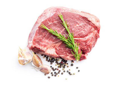 Raw fillet steak beef meat, rosemary, garlic and pepper isolated on the white background.の写真素材