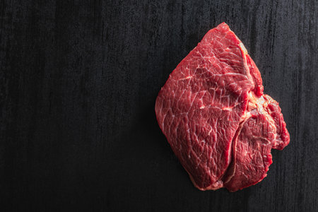 Raw fillet steak beef meat on the black table. Top view.の写真素材