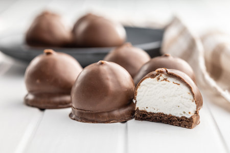 Chocolate covered marshmallows. Sweet dessert on the white table.の写真素材