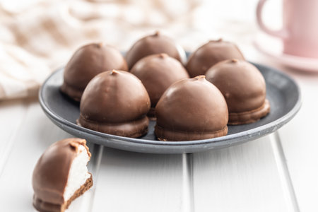 Chocolate covered marshmallows. Sweet dessert on the plate.の写真素材