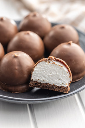 Chocolate covered marshmallows. Sweet dessert on the plate.の写真素材