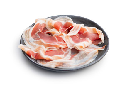 Italian panchetta piancetina. Sliced smoked bacon on a plate isolated on the white background.の写真素材