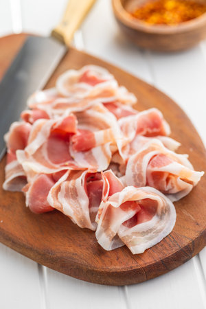 Italian Panchetta. Sliced smoked bacon on the cutting board.の写真素材